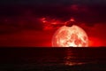 half red blood moon on night sea and back silhouette red cloud Royalty Free Stock Photo