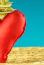 Half of red heart decoration on turquoise background Royalty Free Stock Photo