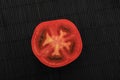 Half a red tomato on a black background Royalty Free Stock Photo