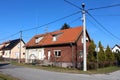 Half renovated small attached suburban street corner family house with two entrances and multiple windows