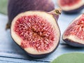 The half of ripe fig fruit on the wooden table. Royalty Free Stock Photo