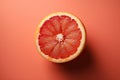 Half of a ripe grapefruit on a color background. AI generated Royalty Free Stock Photo