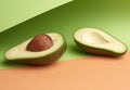 Half ripe green avocado with a brown bone on an abstract green-orange background