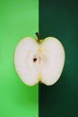 Half a ripe green apple on a green background Royalty Free Stock Photo