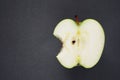 Half a ripe green apple on a gray background Royalty Free Stock Photo