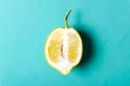 Half of ripe lemon on purple background, top view, minimal composition, summer fruit concept, flat lay Royalty Free Stock Photo