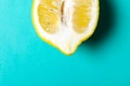 Half of ripe lemon on purple background, top view, minimal composition, summer fruit concept, flat lay Royalty Free Stock Photo