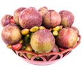 Half ripe mangosteen fruit in a plastic basket Royalty Free Stock Photo