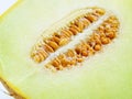 Half of ripe melon with seeds close-up. Sweet green pulp of juicy galia melon. Ingredient for fruit desserts. Vegetarian, raw food