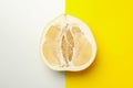 Half of ripe pomelo fruit on two tone background Royalty Free Stock Photo