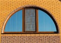 Half-round window in brick wall, house exterior, closeup