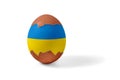 Half shelled Easter chicken egg painted blue and yellow and isolated on a white background Royalty Free Stock Photo