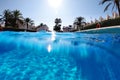 Half shot empty underwater split photography blue water of swimming pool