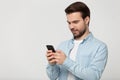 Half side head shot young happy man holding phone. Royalty Free Stock Photo