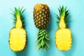 Half slice of fresh pineapple and whole fruit on blue background. Top View. Copy Space. Bright pineapples pattern for Royalty Free Stock Photo