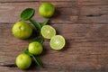 Half sliced lime fruits on wood plate Royalty Free Stock Photo