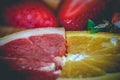 Half slices of ruby red grapefruit and orange Royalty Free Stock Photo