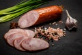 Half of smoked ham sausage with garlic and green onions Royalty Free Stock Photo