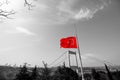 Half-staff Turkish Flag on the pole and monochrome cityscape of Istanbul