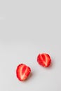 Half strawberries with copyspace on gray background. Vertical photo Royalty Free Stock Photo