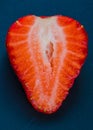 Half of the strawberry without leaves on the black background