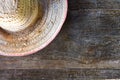 Half striped farmer hat made of woven bamboo on old wood background Royalty Free Stock Photo