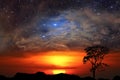 Half sun back red cloud over mountain and nebula galaxy on the sunset sky Royalty Free Stock Photo