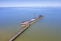 A half-sunken rusty barge at the last berth on the Ob River in Siberia, Russia, in summer