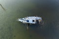 Half sunken sailing yacht capsized on shallow bay waters after hurricane Ian in Manasota, Florida Royalty Free Stock Photo