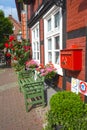 A half-timbered house in the German medieval town Hitzacker. In front of the house you can see a bench, flowers and a red mailbox