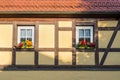 Half-timbered house with window and colorful flowers Royalty Free Stock Photo