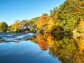 Half-timbered houses on the river bank. View on the Wipperkotten on the Wupper river. Beautiful golden autumn in Solingen.