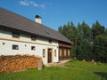 half timbered masonry old rustic house with chopped wood and green grass Royalty Free Stock Photo