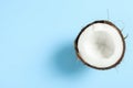 Half tropical coconut on color background