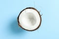 Half tropical coconut on color background