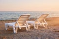 Half-turn view chaise longues on the beach. Royalty Free Stock Photo