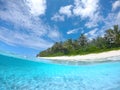 HALF UNDERWATER: Idyllic beach is being washed by the gentle glassy ocean waves. Royalty Free Stock Photo