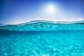 Half underwater shot, clear water and sunny blue sky. Tropical ocean Royalty Free Stock Photo