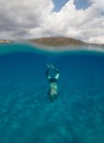 Half underwater view of a senior man with stunning landscape in south Sardinia named Mari Pintau - italy 2