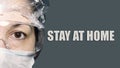 Half view of doctor face and Stay at home text. Young female wearing medical mask against coronavirus. Woman scientist in mask