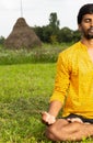 Half-view of indian man practicing lotus position