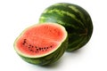 Half watermelon with seeds next to whole watermelon isolated on Royalty Free Stock Photo