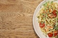 Half of a white dish with shrimp scampi and linguine in on a wood table from top view Royalty Free Stock Photo