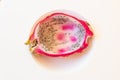 Half of a white dragon fruit with pulp spooned out on white bowl, centered Royalty Free Stock Photo