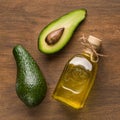 Half and whole avocado and oil in bottle