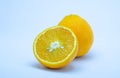 half and whole orange on white background