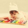 Half year baby girl playing with xylophone toy on blanket Royalty Free Stock Photo