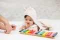 Half year baby girl playing with xylophone toy on blanket Royalty Free Stock Photo