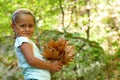 4 and a half year old girl shows a bouquet of leaves