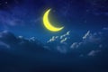 Half yellow moon behind cloudy on sky and star at night. Outdoor